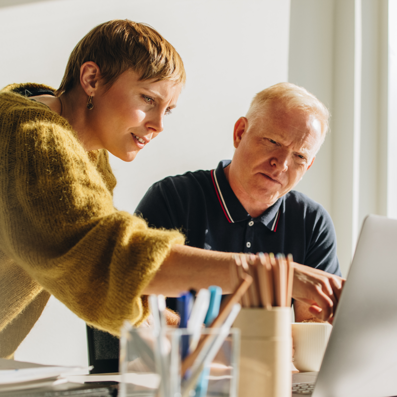 Man and Women Working on Laptop